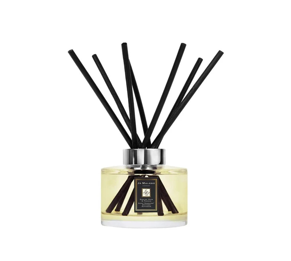 Jo Malone English Pear & Freesia Diffuser in a 165ml clear glass container with black reeds, offering a fresh floral scent.
