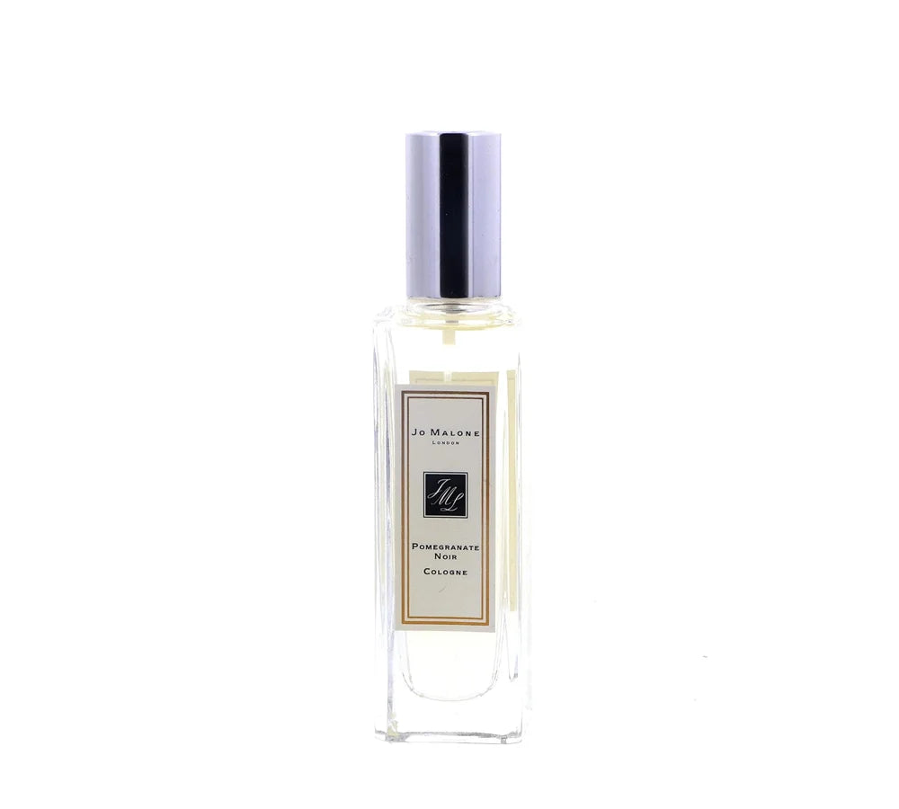 A rectangular glass bottle of Jo Malone Pomegranate Noir Cologne Spray for Women, 1 oz, featuring a polished silver cap and a classic cream and black label design.