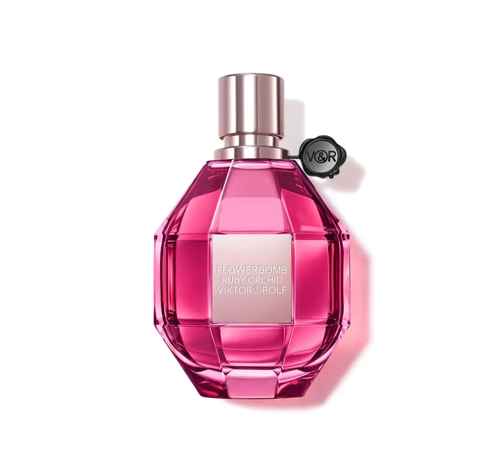 Viktor & Rolf Flowerbomb Ruby Orchid Eau de Parfum 100ml in a faceted, ruby-colored glass bottle with a signature black seal and metallic pink cap.