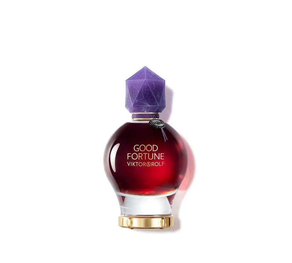 A 90ml bottle of Viktor & Rolf Good Fortune Elixir, featuring a deep purple potion-like design with a gold cap and mystical aesthetic.
